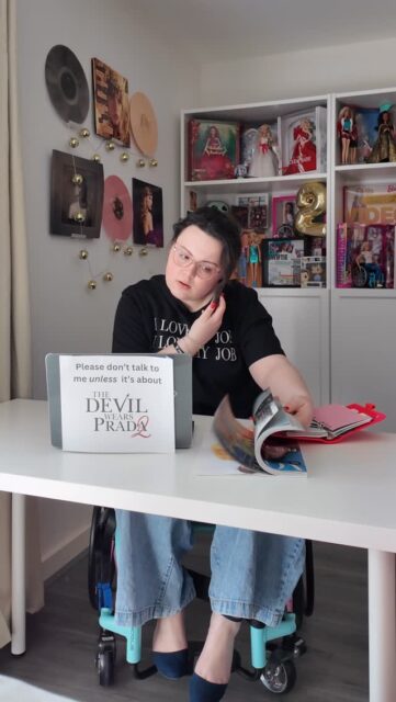 Gird your loins, Runway! By all means feel free to move at a glacial pace, I’ll be here waiting for @tdwp2 and my invite to the premiere 👠VD: A woman with clipped up brown curly hair, sitting in her office space in a wheelchair. She is wearing Jeans, heels and a tshirt. Her laptop has a sign attached which says ‘Please don’t talk to me unless it’s about The Devil Wears Prada 2’.