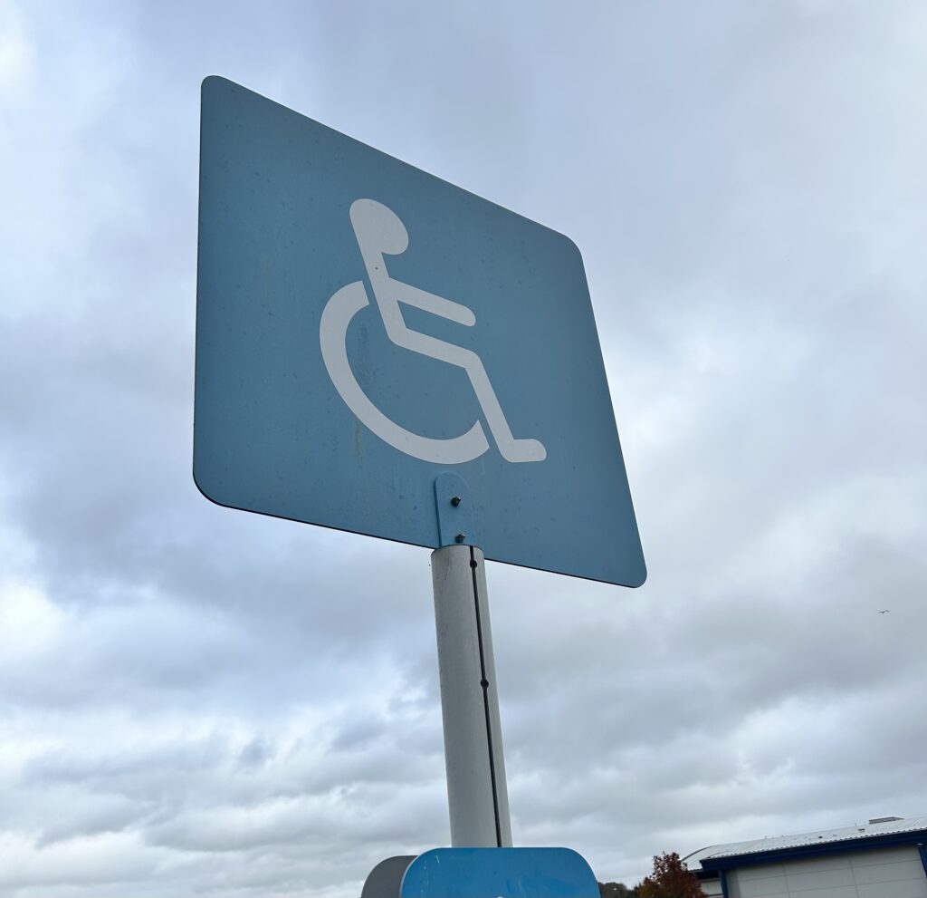 Disability Signage outdoors on a cloudy day