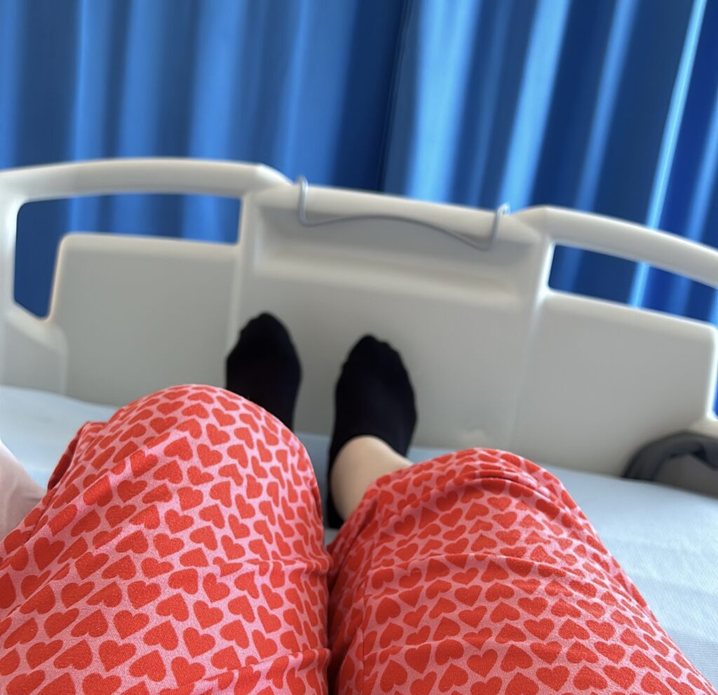 A photo of a womans feet in a hospital bed during an admission for inflammatory enteropathic arthritis